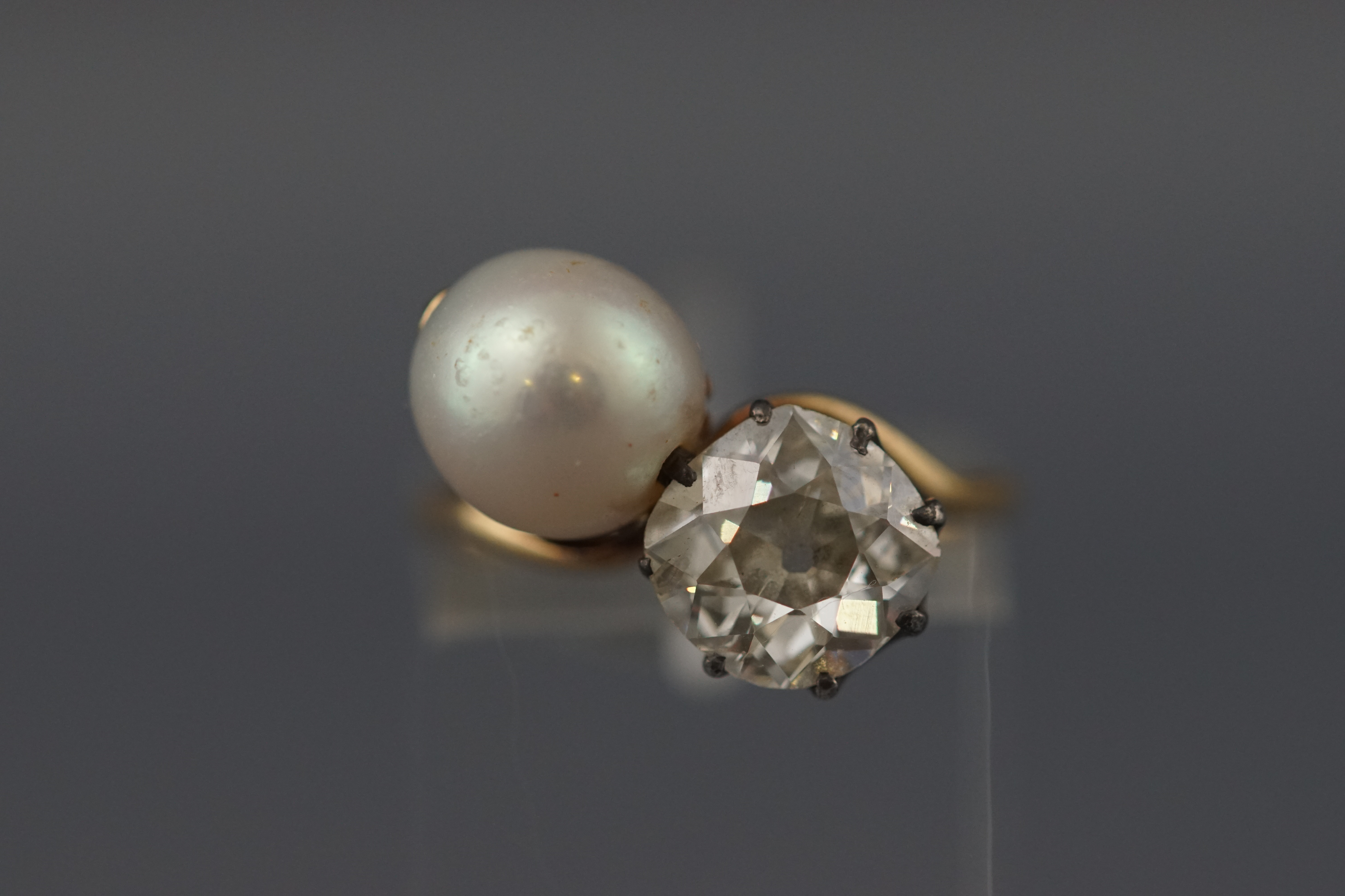 A yellow and white metal two stone ring. Set with an old mine cut diamond approx 1.