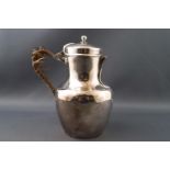 A white metal jug by Christofle, of baluster form with domed lid.
