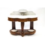 A fancy shaped mahogany white marble topped wash stand,