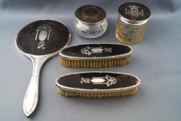 A tortoiseshell and silver mounted three piece dressing table set,