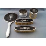 A tortoiseshell and silver mounted three piece dressing table set,
