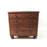 A miniature chest of drawers with a plain top over two short and three long drawers with turned