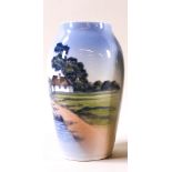A Royal Copenhagen vase, decorated with a cottage upon the shoreline,