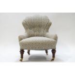 A Victorian button back nursing chair with shell shaped back, raised on turned mahoganty front legs,
