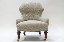 A Victorian button back nursing chair with shell shaped back, raised on turned mahoganty front legs,