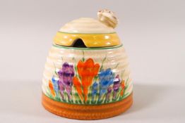 A Clarice Cliff Newport Pottery Spring Crocus pattern 'beehive' preserve pot and cover, 9.