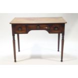 A George IV mahogany writing table with three drawers on tapered legs,