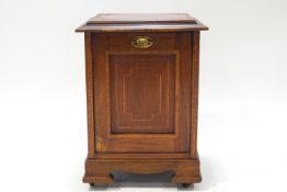 An Edwardian mahogany coal purdonium, inlaid with satinwood crossbanding and raised on bracket feet,