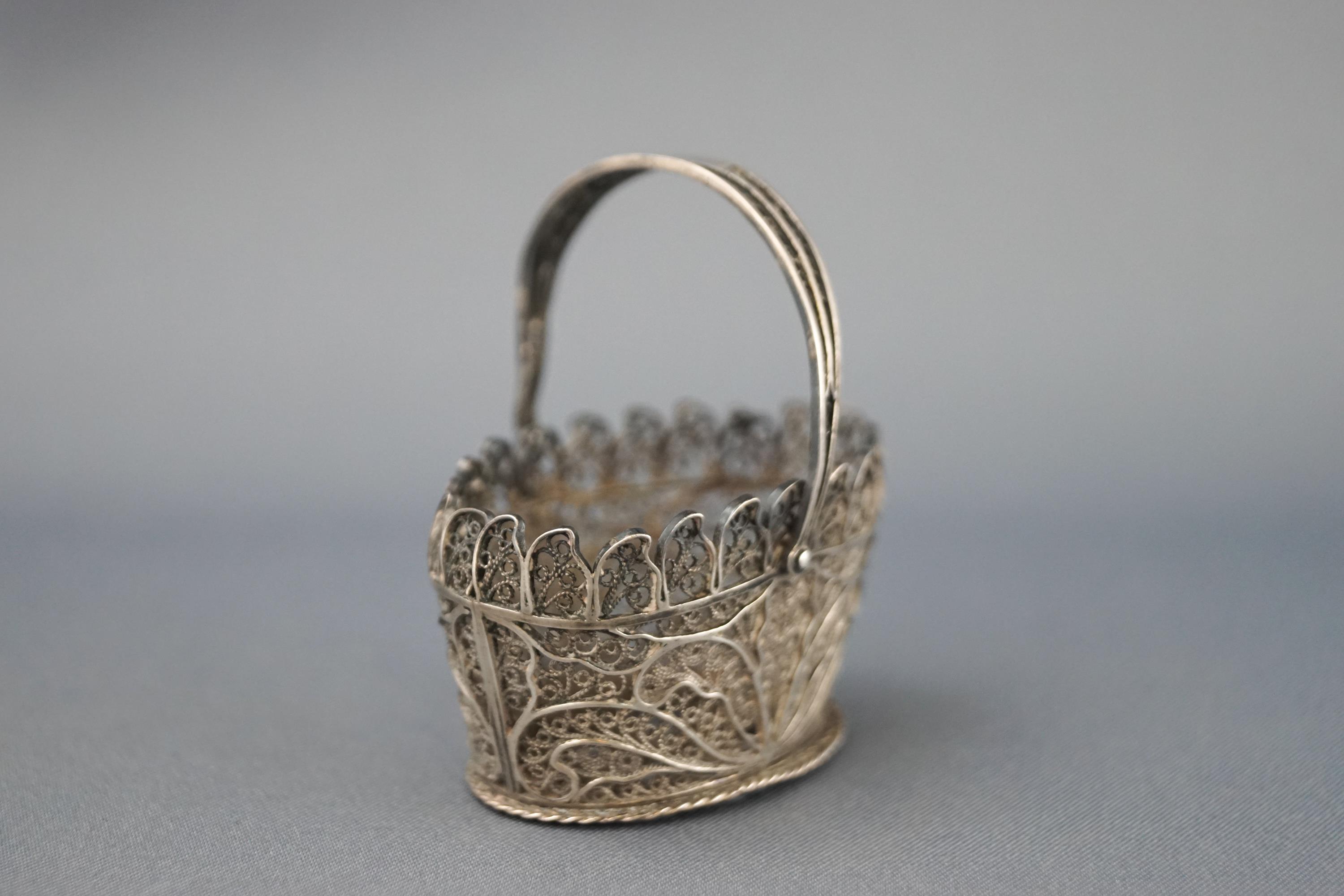 A white metal filigree basket 11.