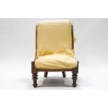 A 19th mahogany framed nursing chair on turned and fluted legs,