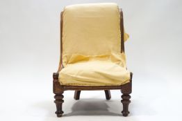 A 19th mahogany framed nursing chair on turned and fluted legs,