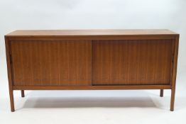 A 1960's Gordon Russell American black walnut and cherry dining suite, comprising extending table,