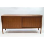 A 1960's Gordon Russell American black walnut and cherry dining suite, comprising extending table,