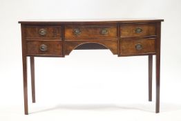 A mahogany bow front sideboard with and arrangement of four drawers on square tapering legs,