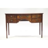 A mahogany bow front sideboard with and arrangement of four drawers on square tapering legs,