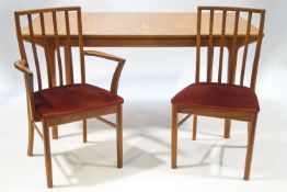 A 1972 Macintosh teak table together with four chairs and two carvers, the table top 159cm x 92cm,