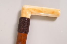 A Malacca shafted walking stick with late Victorian ivory handle and leather collar