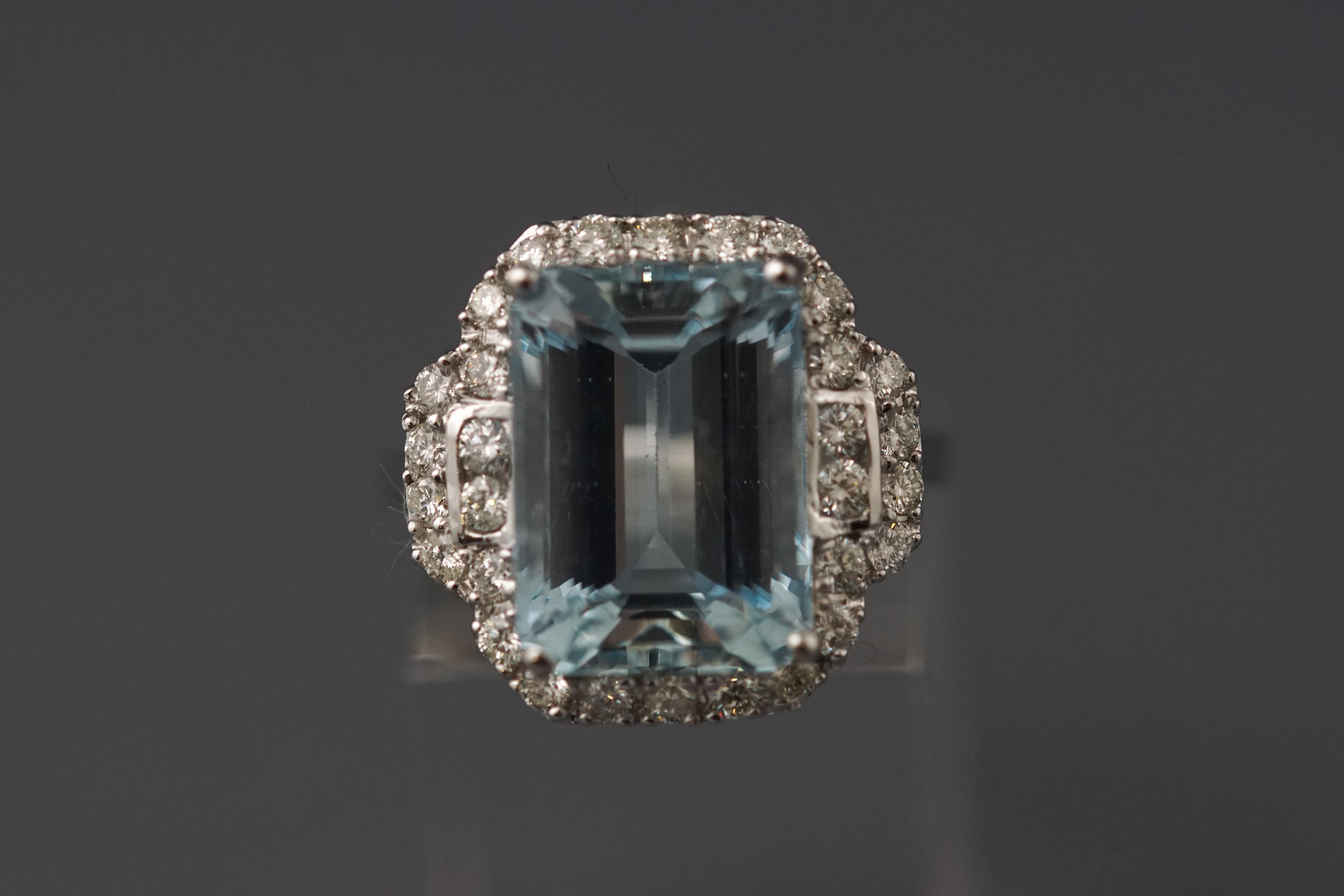 A white metal aquamarine and diamond cluster ring.