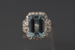 A white metal aquamarine and diamond cluster ring.