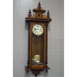 A Gustav Becker Vienna wall clock, the mixed hardwood case with a shaped cresting,