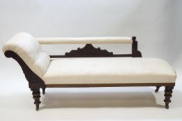 A Victorian mahogany chaise longue with button back cream upholstery,
