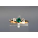 A yellow and white metal three stone ring set with green and white zircons. Stamped Plat 9ct.