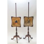 A pair of 19th century rosewood fire pole screens on tripod bases set with a Berlin wool work panel