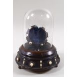 A Victorian turned wood pocket watch holder with hinged glass dome,