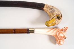 Two slim walking canes, one with eagle's head handle,