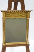 A 19th century giltwood wall mirror with ball decoration to the frieze and pilasters to either side,