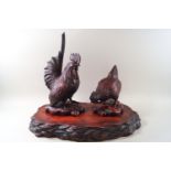 Two 20th Japanese lacquer chickens on stand, the cockerel 33cm high and the hen 20cm,
