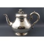 A Victorian pear shaped silver tea pot with applied scroll handle,