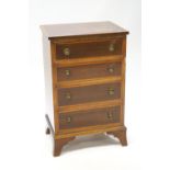 An Edwardian mahogany small chest of four drawers with satinwood cross banding on bracket feet,