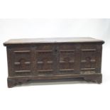 A sizeable 17th/18th century oak coffer, the front with carved arches, birds and foliage,