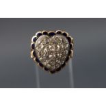 A yellow metal heart shaped ring set with twenty four old brilliant cut diamonds measuring from 2.