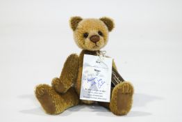 A Charlie Bear, 'Eric', number 52 of 500, with tags, signed by Charlie, 22cm high,