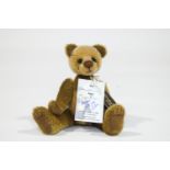 A Charlie Bear, 'Eric', number 52 of 500, with tags, signed by Charlie, 22cm high,