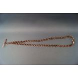 A rose gold albert chain with T-bar and double swivel attachments. Hallmarked 9ct gold.