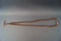 A rose gold albert chain with T-bar and double swivel attachments. Hallmarked 9ct gold.