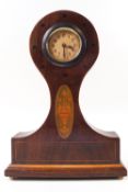 An Edwardian mahogany balloon clock with round Arabic dial,