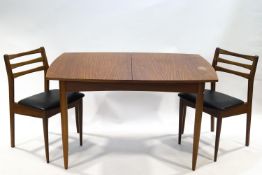 A 1970's White & Newton extending dining table, the top with hidden folding leaf,