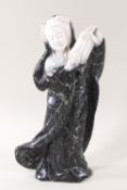 A carved hard stone figure of an oriental courtesan dancing with a fan,
