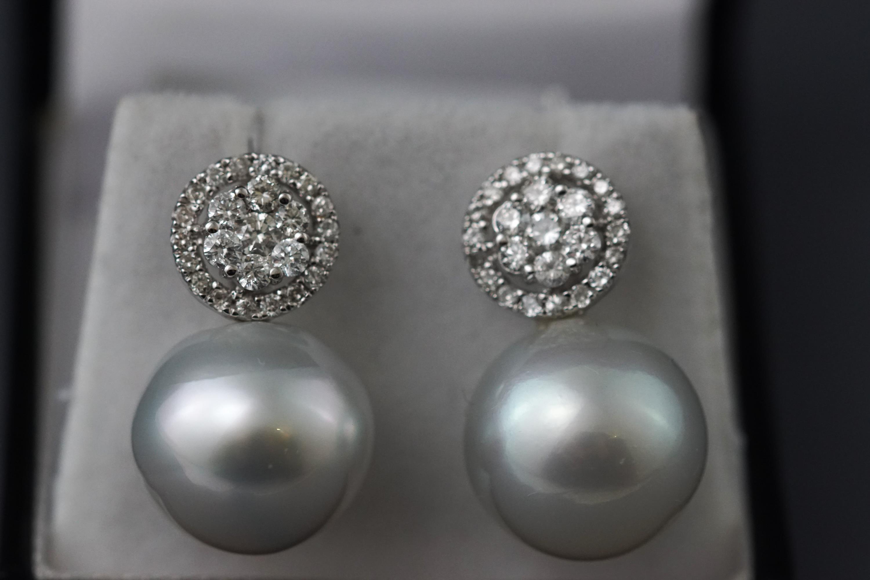 A white metal pair of South Sea pearl and diamond drop earrings.