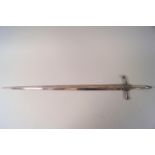 A sword shaped white metal skewer,