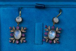 A 9ct and silver gilt pair of drop earrings each set with moonstones,