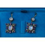 A 9ct and silver gilt pair of drop earrings each set with moonstones,