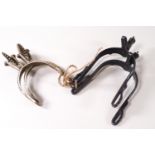 Two pairs of Spanish spurs, one pair in white metal, the other in blackened steel, stamped Lopez,