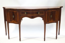 A George III mahogany sideboard with serpentine front and satinwood cross banding on square
