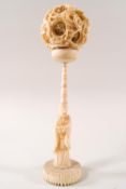 An early 20th century Chinese ivory concentric puzzle ball on carved ivory stand,