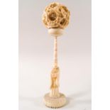 An early 20th century Chinese ivory concentric puzzle ball on carved ivory stand,